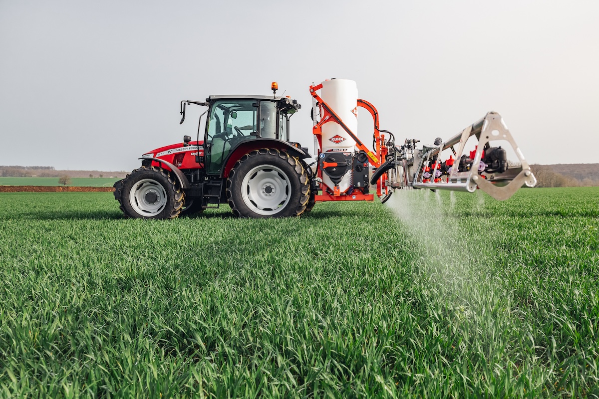 Il trattore Massey Ferguson MF 5711 M durante l'irrorazione con sprayer